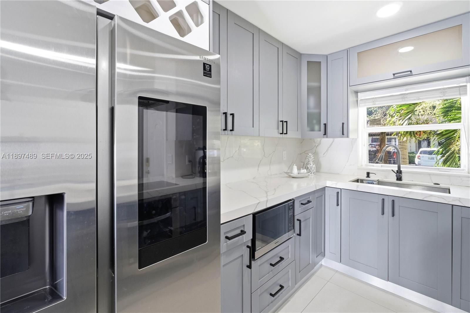 13765 Southwest 54th Lane Miami, FL 33175 - Photo 8 of 30 a kitchen with white cabinets and a sink