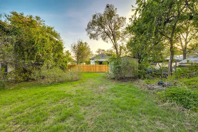 a backyard of a house with trees and entertaining space