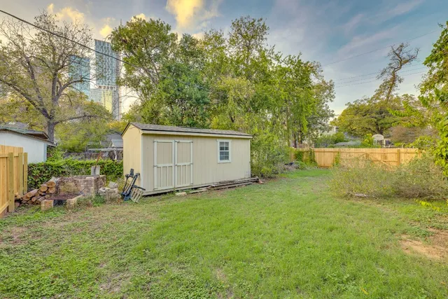 a view of a backyard with table and chairs and potted plants