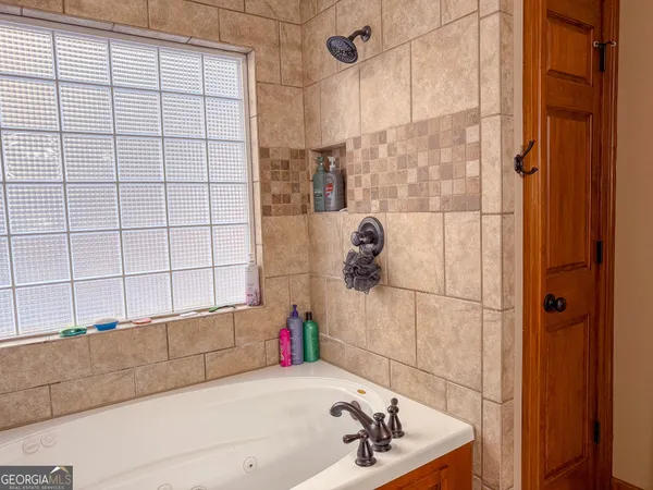 a bathroom with a bathtub and shower