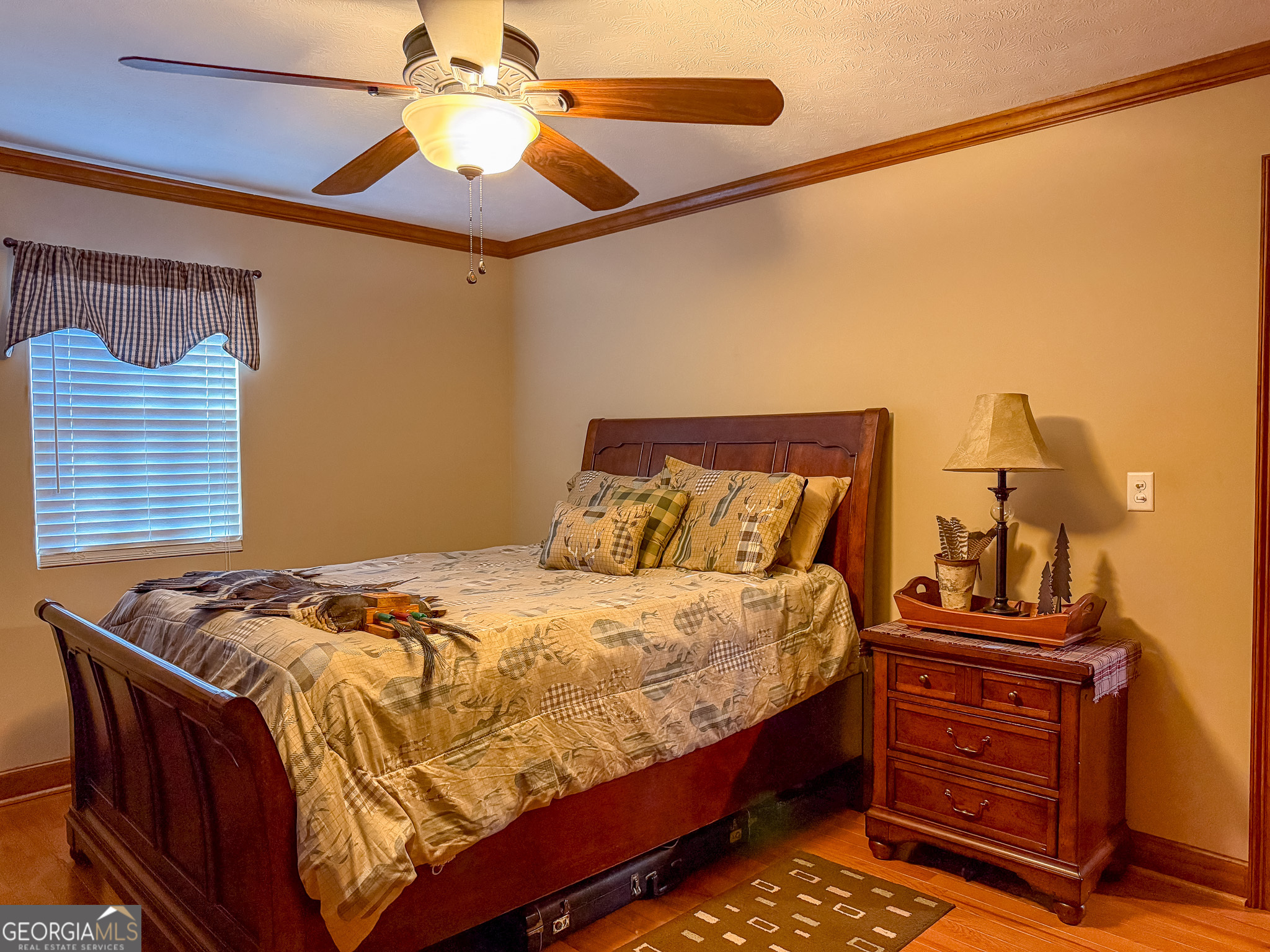 721 Thrasher Road Plains, GA 31780 - Photo 14 of 27 a bedroom with a bed and a chandelier
