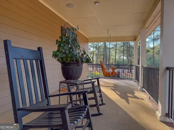 a view of balcony with couple of chairs