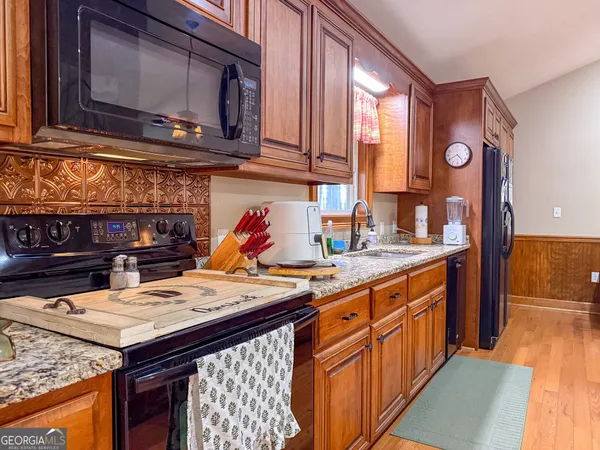 a kitchen with a sink a stove and cabinets