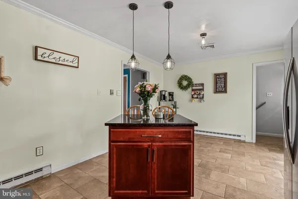a view of a hallway with a table and chairs