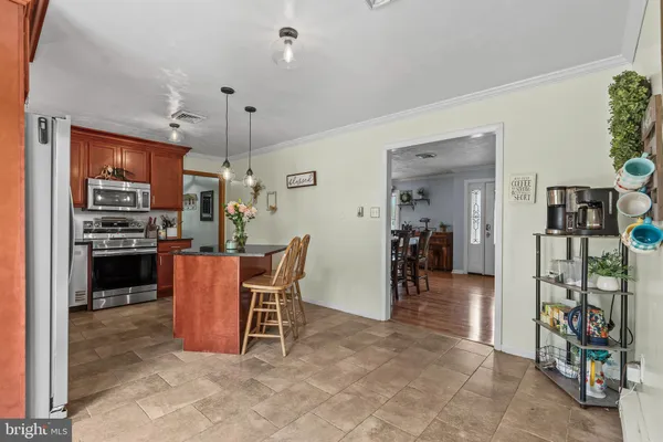 a dining room filled with furniture and a kitchen