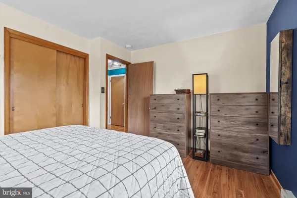 a bedroom with a bed and a flat tv screen