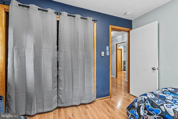 a bedroom with a bed and a mirror