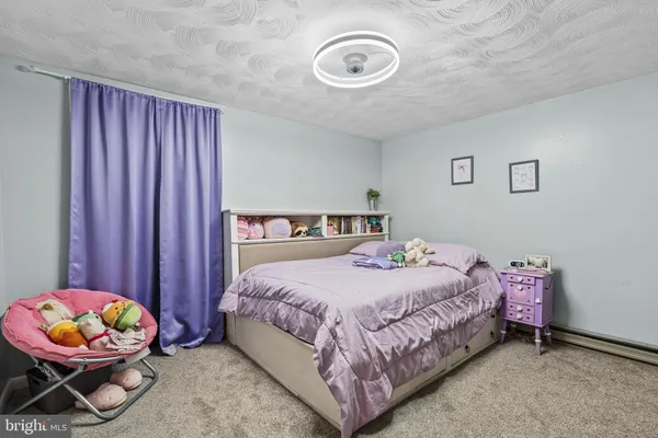 a bedroom with a bed a couch and a chair