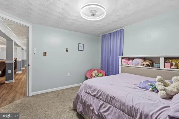 a bedroom with a bed and a book shelf