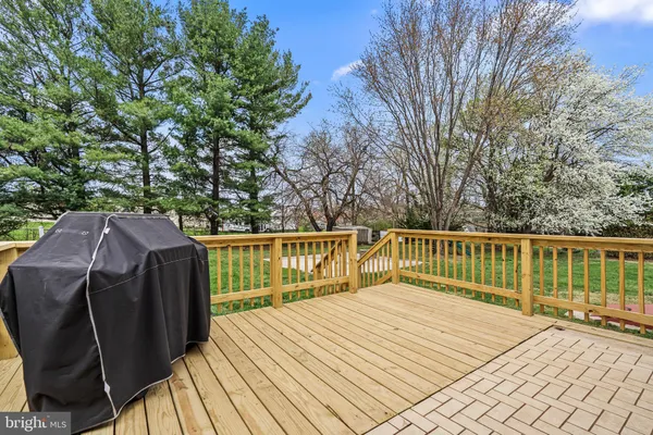 a view of balcony with wooden floor and fence