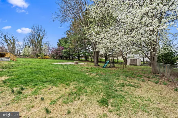 a huge green field with lots of trees