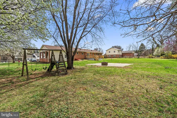 a view of a playground with a yard and plants