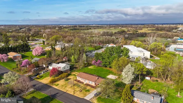 an aerial view of residential house with pool and garden space