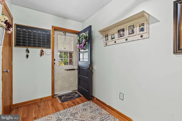 a view of an entryway with wooden floor