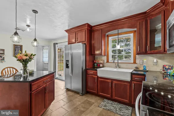 a kitchen with a sink appliances and cabinets