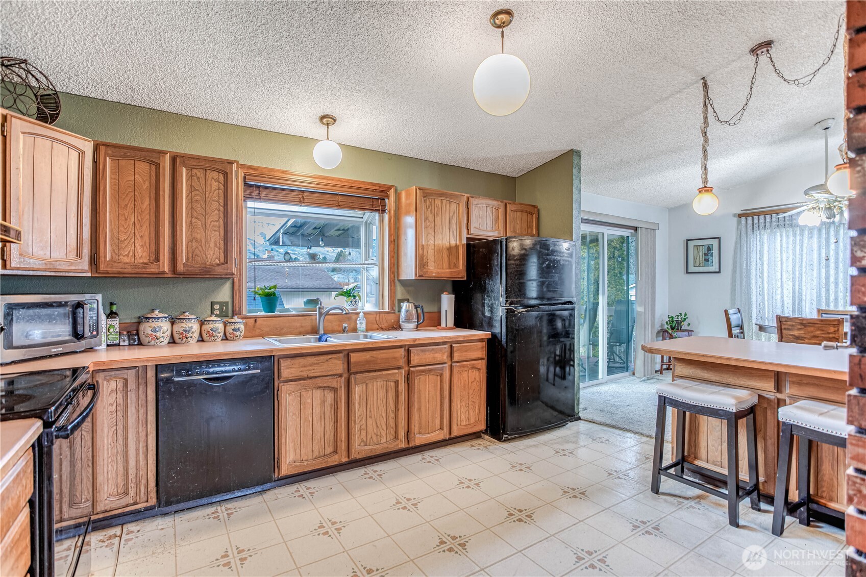 920 Willis Street Wenatchee, WA 98801 - Photo 11 of 33 a kitchen with stainless steel appliances granite countertop a sink and cabinets