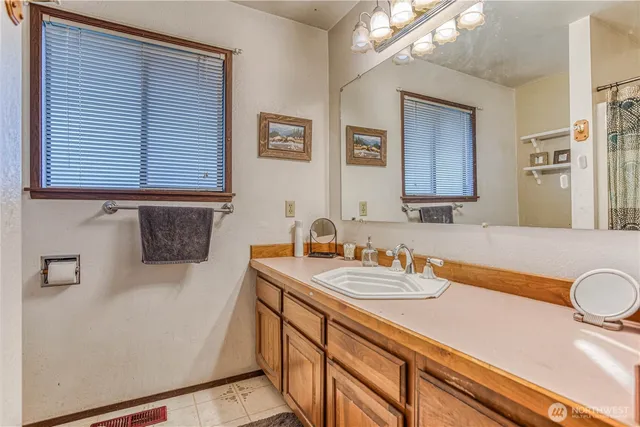 a bathroom with a sink a vanity and a mirror