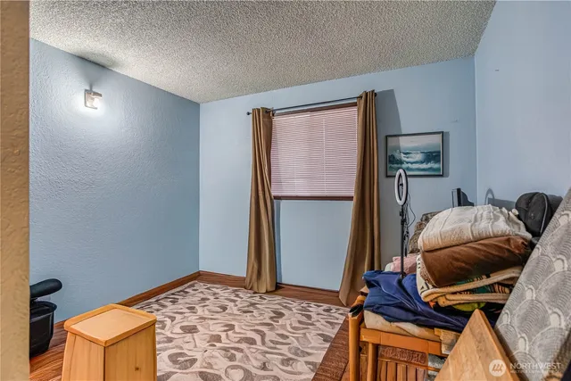 a bedroom with a bed and a refrigerator