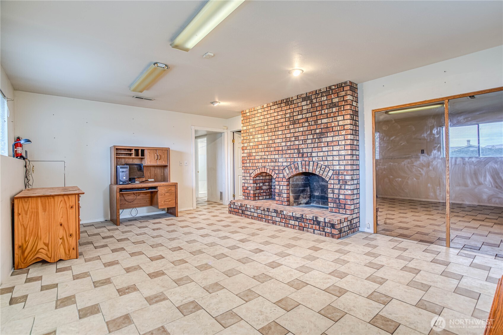 920 Willis Street Wenatchee, WA 98801 - Photo 23 of 33 a living room with furniture a dining table and a fireplace