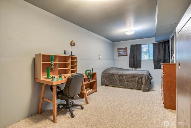 a bedroom with a bed and a desk