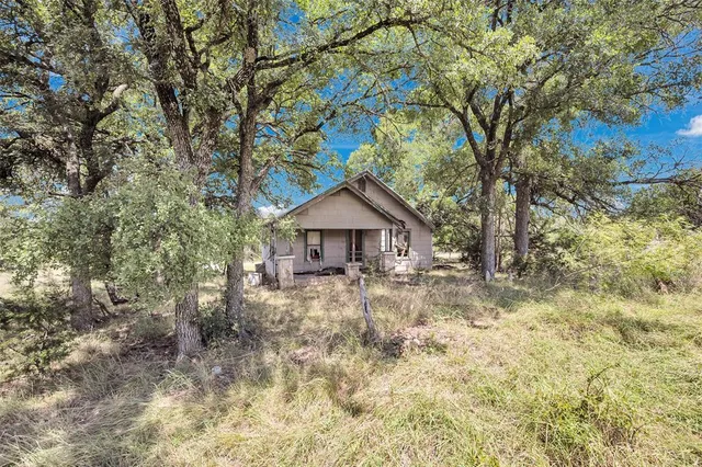 a backyard of a house with large trees