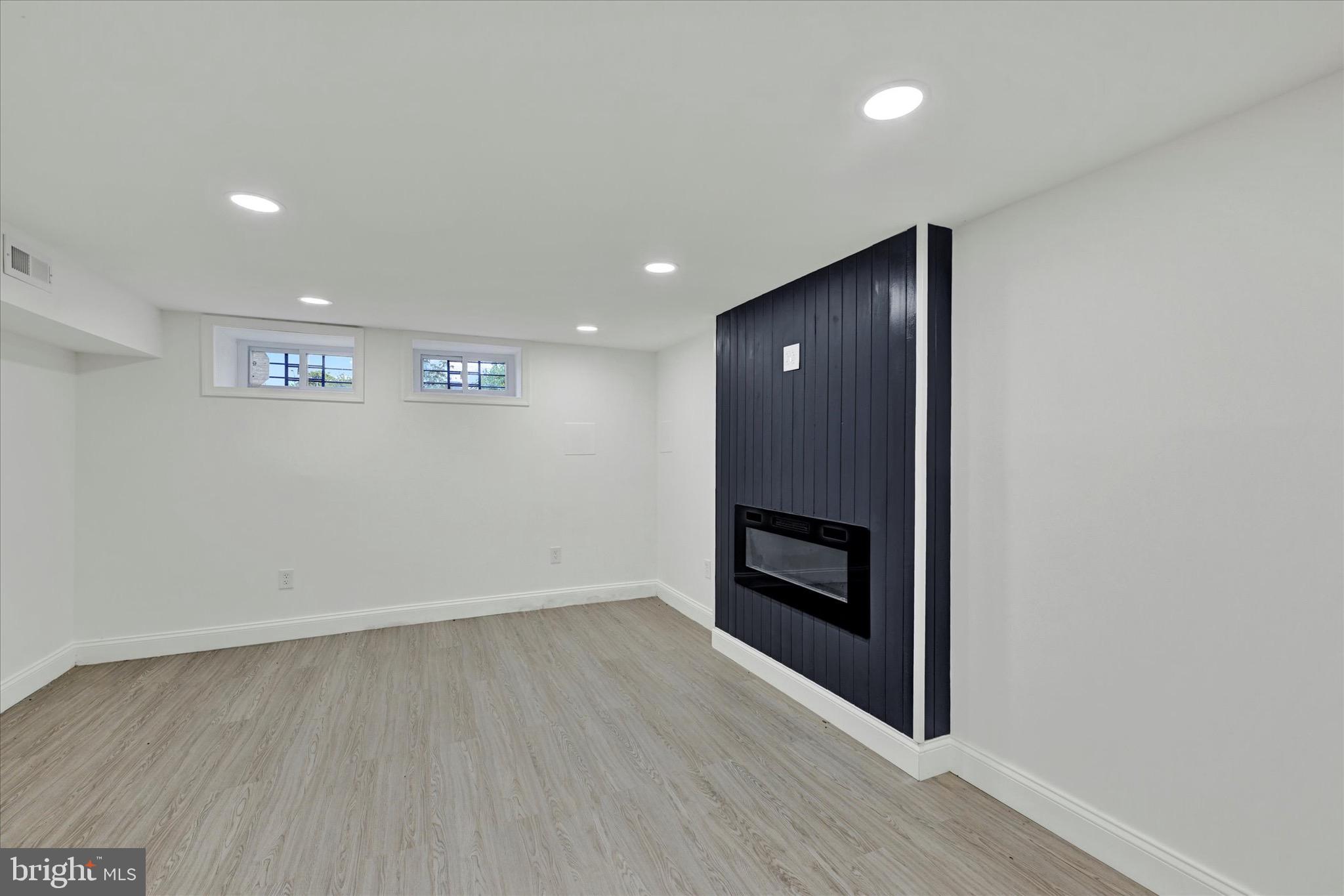 1748 North Chester Street Baltimore, MD 21213 - Photo 20 of 27 an empty room with wooden floor and entrance