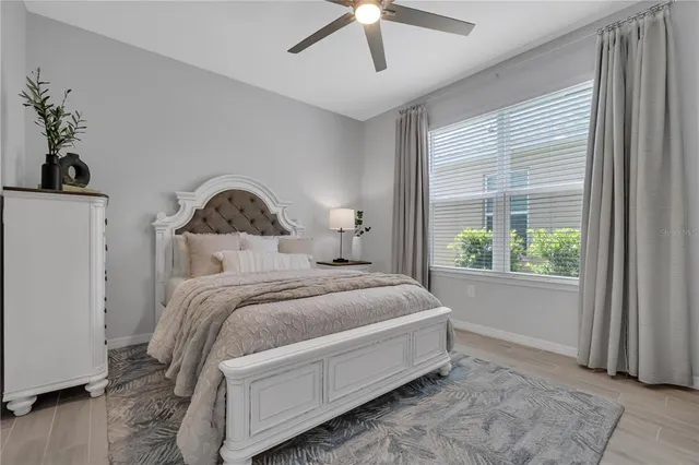 a spacious bedroom with a bed and a window