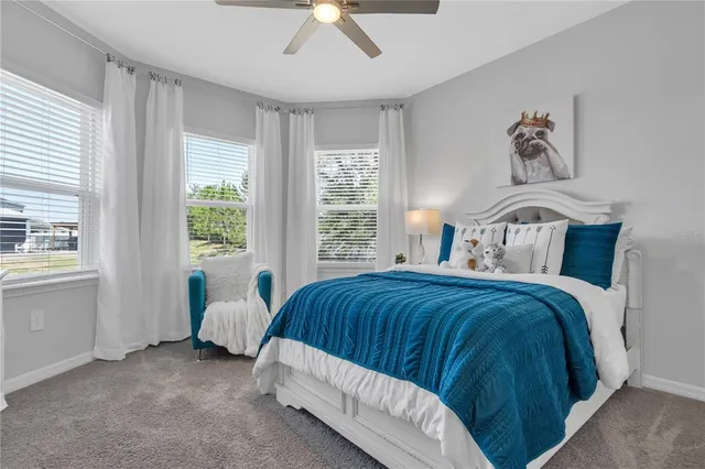 a bedroom with a bed a couch and a window