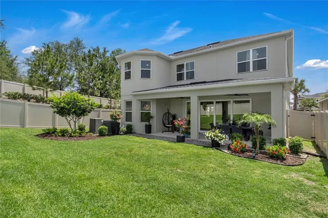 a view of a house with a yard and sitting area