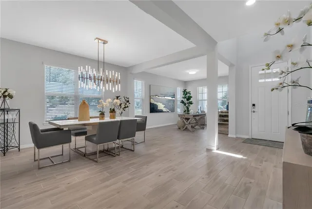 a view of a dining room with furniture wooden floor and chandelier