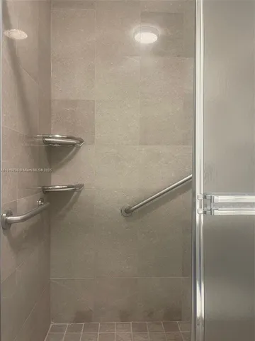 a bathroom with a glass shower door