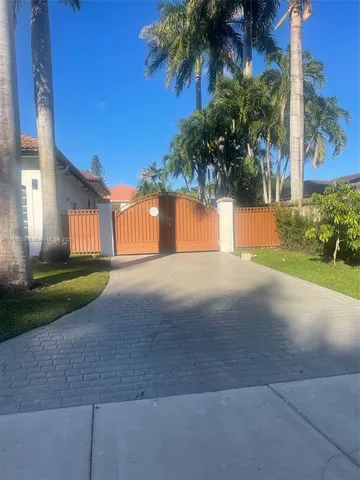 a view of a house with a yard and potted plants
