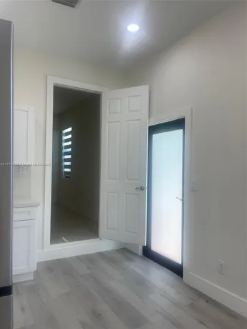an empty room with wooden floor and closet