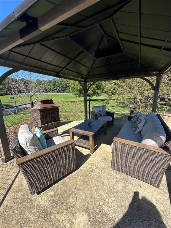 3400 North Sharon Church Road Loganville, GA 30052 - Photo 15 of 53 a outdoor living space with furniture and a garden