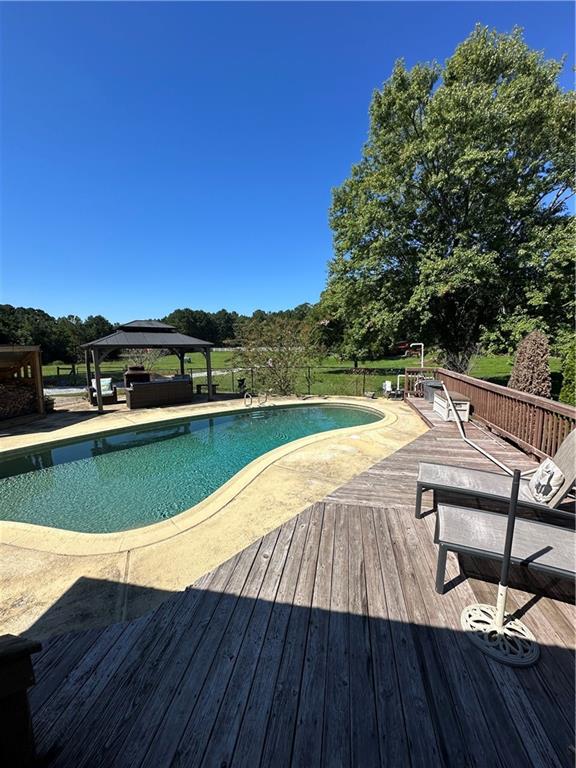 3400 North Sharon Church Road Loganville, GA 30052 - Photo 16 of 53 a view of swimming pool with outdoor seating