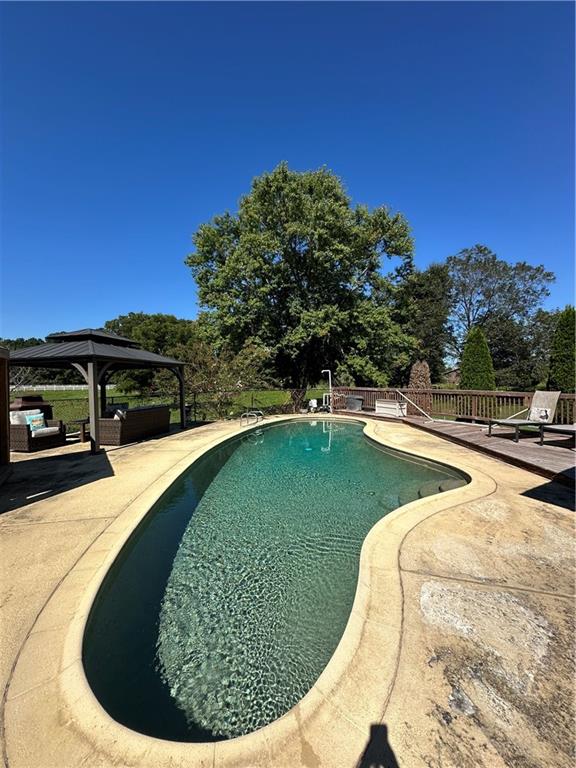 3400 North Sharon Church Road Loganville, GA 30052 - Photo 20 of 53 a view of a swimming pool with a yard
