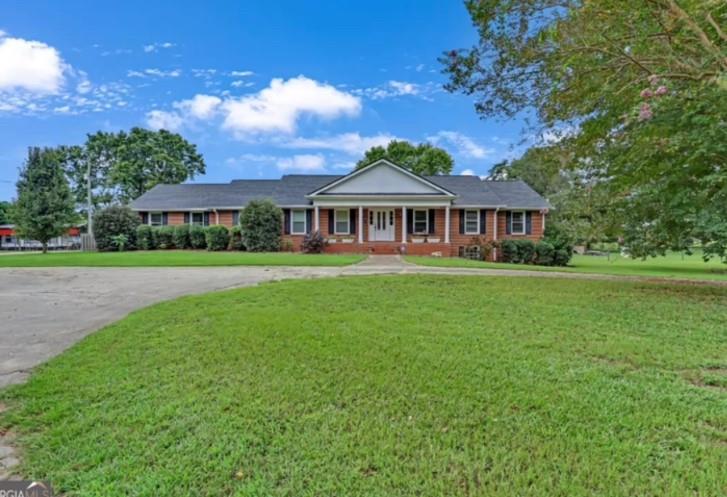 3400 North Sharon Church Road Loganville, GA 30052 - Photo 2 of 53 a view of a house with a big yard