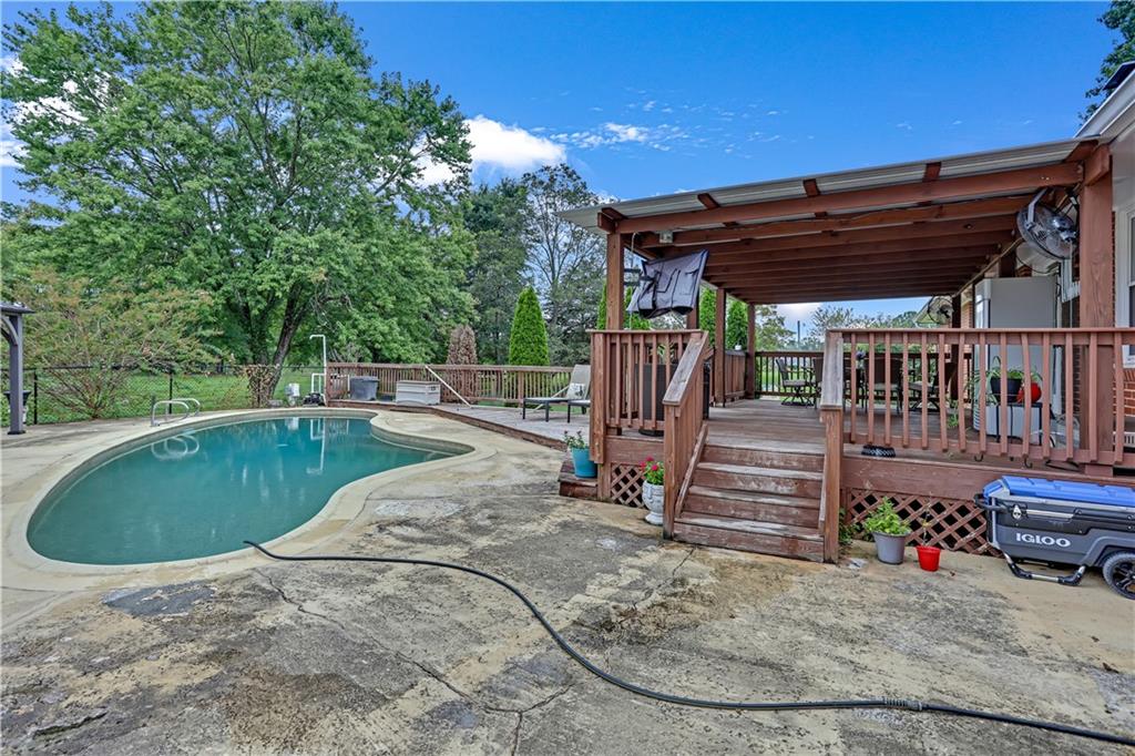 3400 North Sharon Church Road Loganville, GA 30052 - Photo 25 of 53 a view of a backyard with wooden deck and furniture