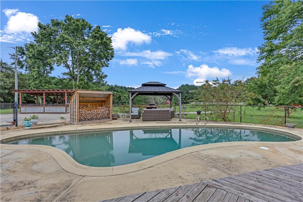 3400 North Sharon Church Road Loganville, GA 30052 - Photo 29 of 53 a view of a house with a swimming pool