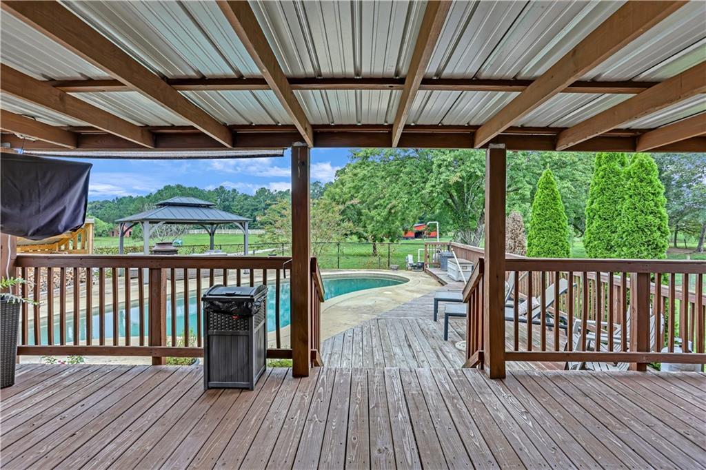 3400 North Sharon Church Road Loganville, GA 30052 - Photo 30 of 53 a view of balcony with wooden floor and outdoor seating