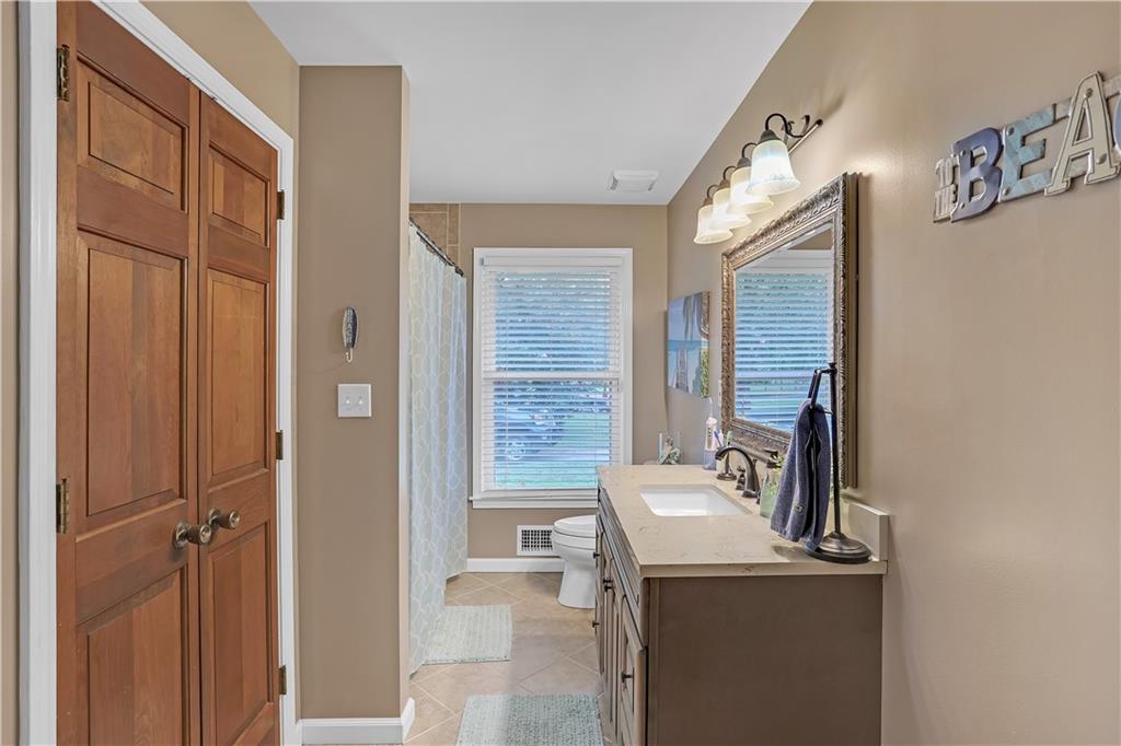 3400 North Sharon Church Road Loganville, GA 30052 - Photo 33 of 53 a bathroom with a sink and a mirror