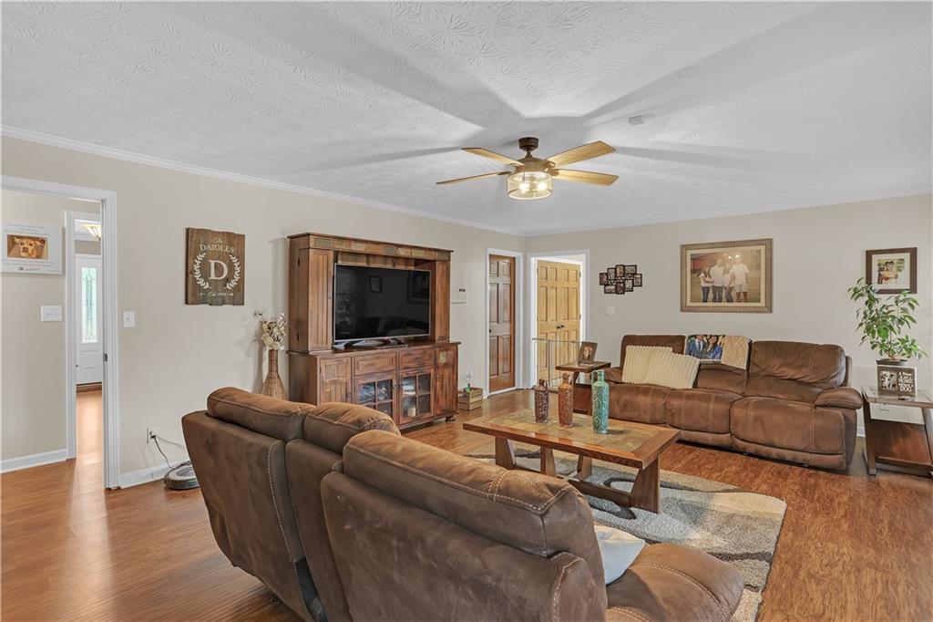 3400 North Sharon Church Road Loganville, GA 30052 - Photo 38 of 53 a living room with furniture a flat screen tv and a window