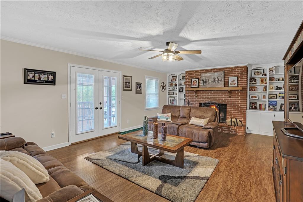 3400 North Sharon Church Road Loganville, GA 30052 - Photo 39 of 53 a living room with furniture a fireplace and a table