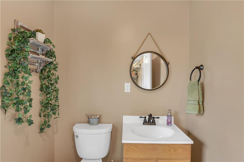 3400 North Sharon Church Road Loganville, GA 30052 - Photo 41 of 53 a bathroom with a toilet sink and mirror