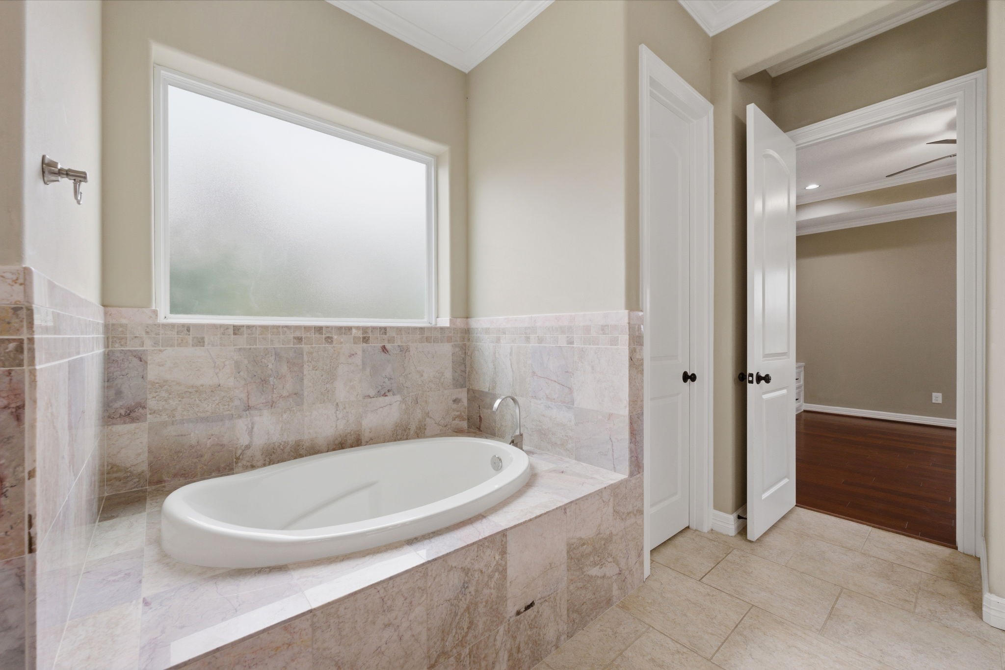 8403 Greenridge Manor Lane Spring, TX 77389 - Photo 27 of 48 This bathroom features a luxurious oval soaking tub with elegant tile surround, frosted window for privacy.