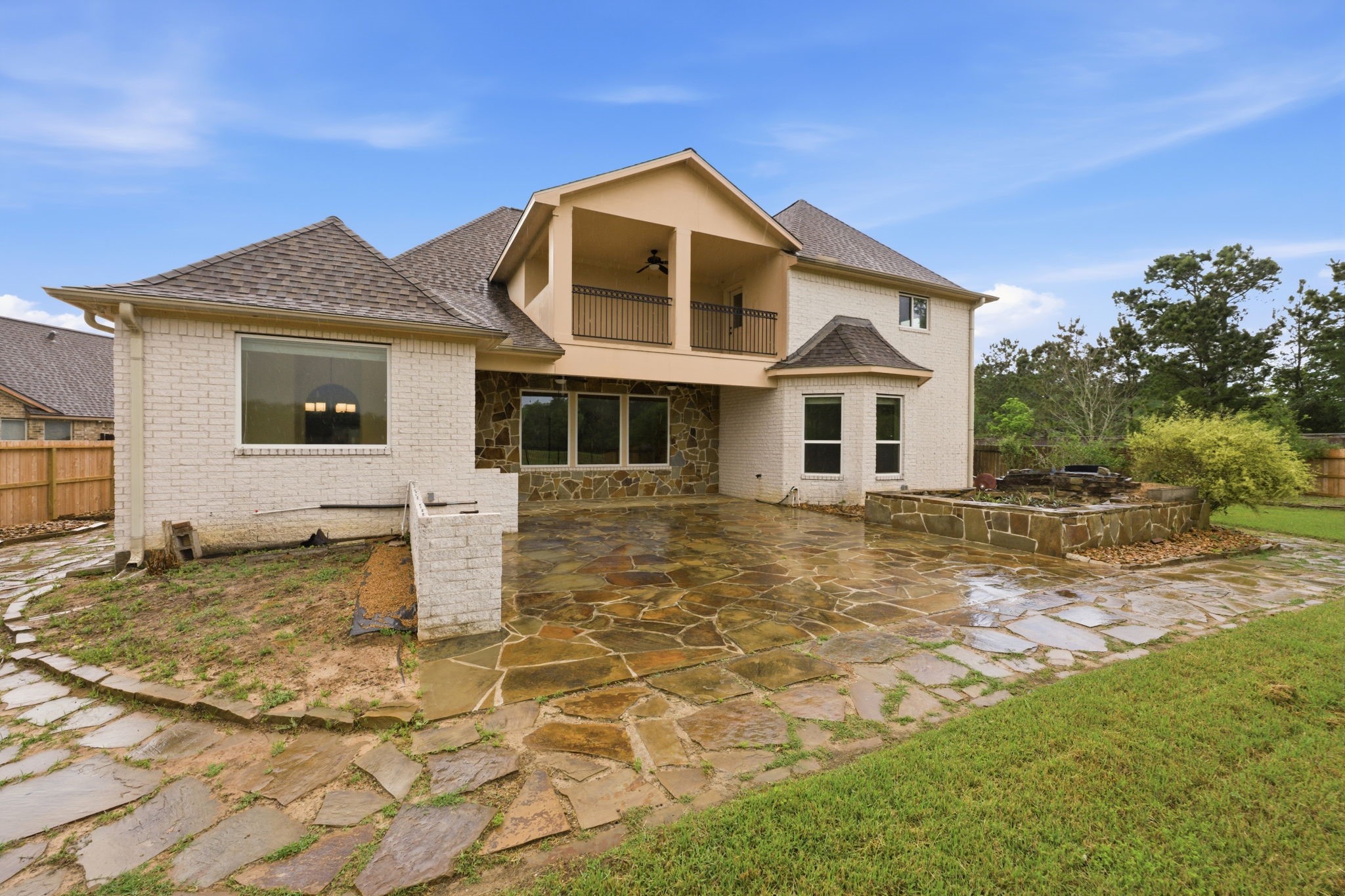 8403 Greenridge Manor Lane Spring, TX 77389 - Photo 43 of 44 Spacious backyard with a large stone patio, perfect for outdoor entertaining.