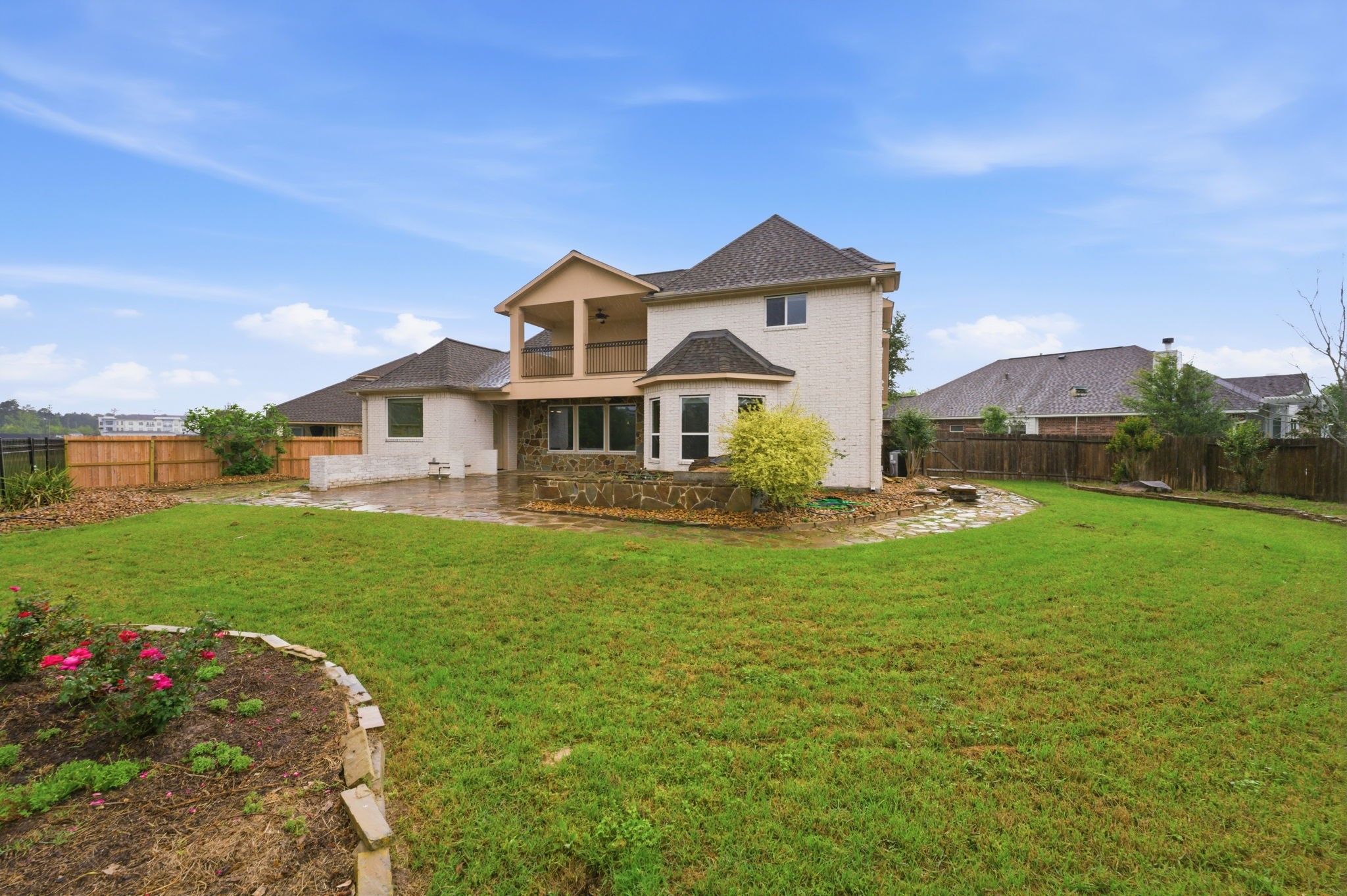 8403 Greenridge Manor Lane Spring, TX 77389 - Photo 44 of 44 This photo shows a two-story house with a spacious, well-maintained backyard. It features a patio area and a fenced perimeter, ideal for outdoor activities and privacy.