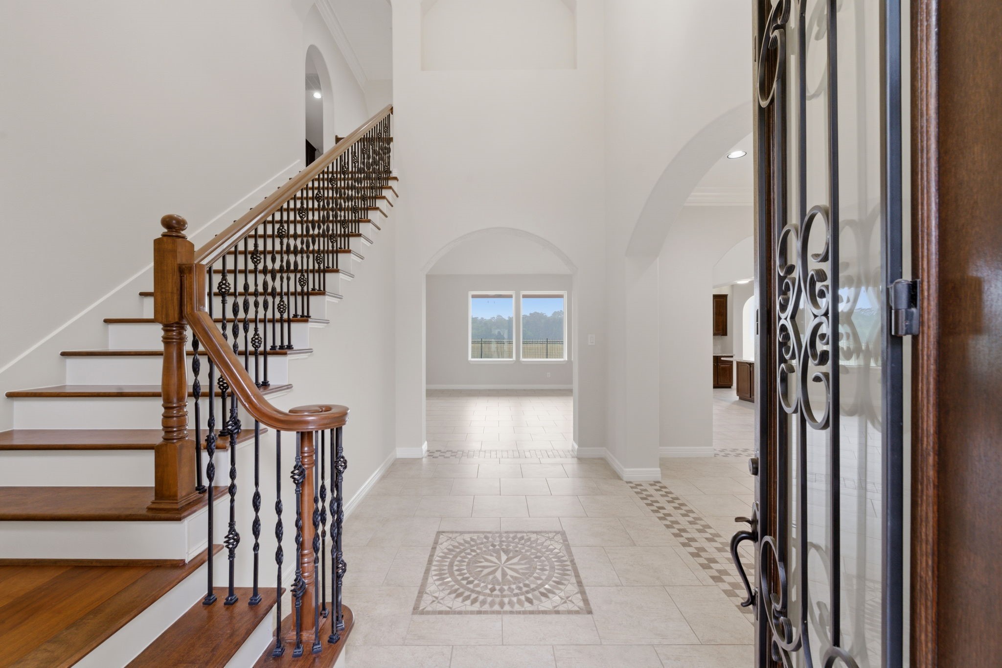8403 Greenridge Manor Lane Spring, TX 77389 - Photo 5 of 44 Wrought iron staircase and a frosted glass front door for added light and charm. Opening to a bright, spacious family room.