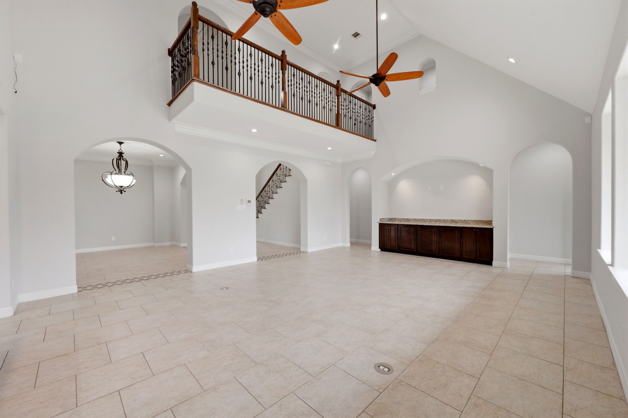 8403 Greenridge Manor Lane Spring, TX 77389 - Photo 10 of 48 The room is filled with natural light from ample windows, arched doorways lead to additional spaces, enhancing the open feel.