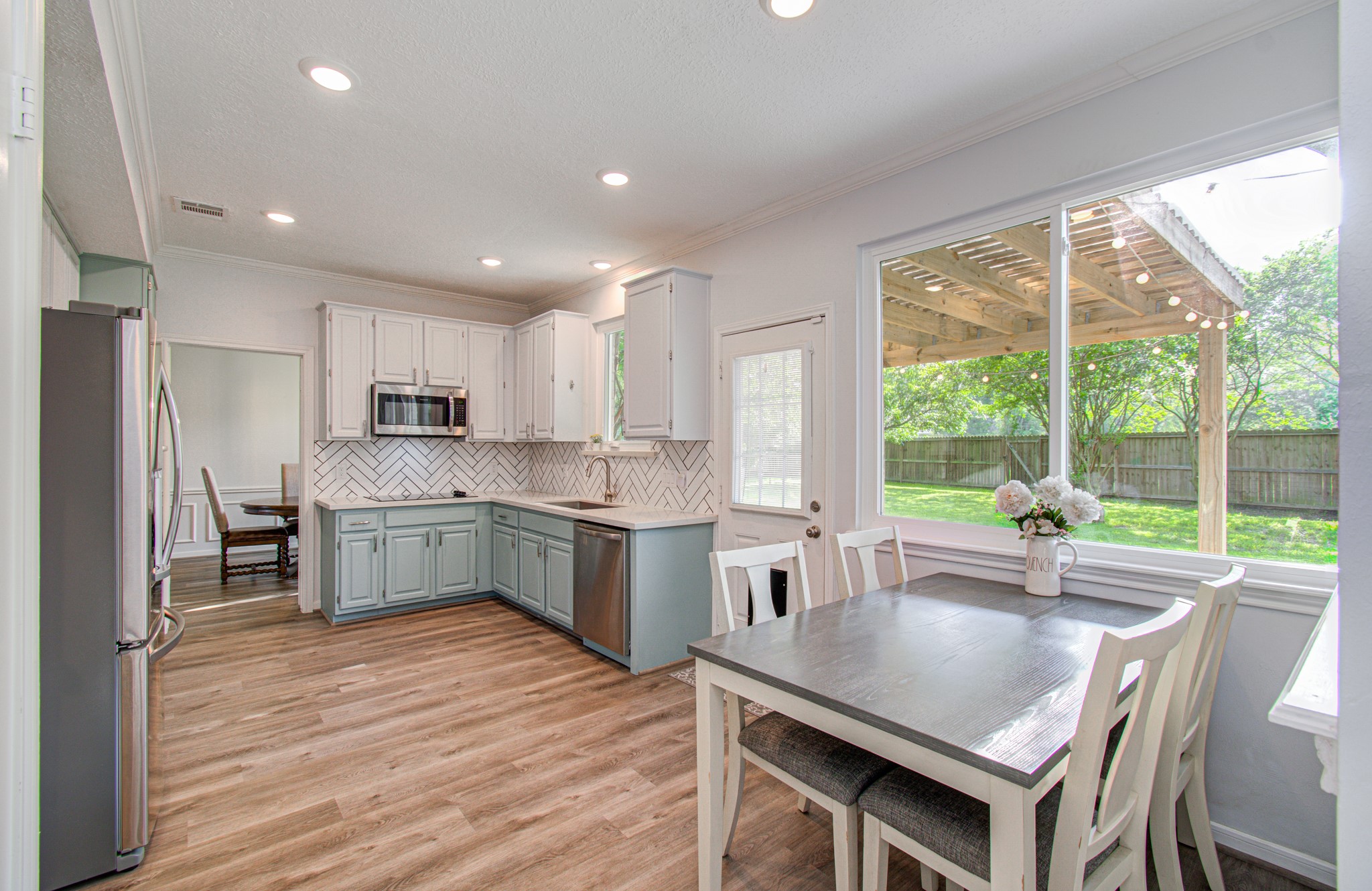 22927 Northoak Forest Lane Spring, TX 77389 - Photo 11 of 37 a kitchen with a table chairs microwave and refrigerator